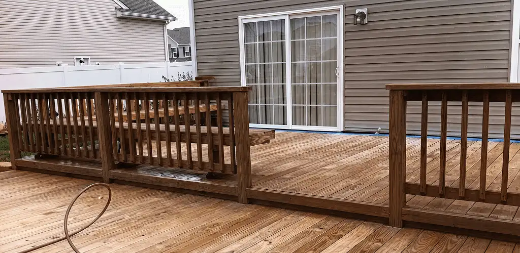 Deck sealing service protecting a backyard wood deck and railings in Louisville, KY