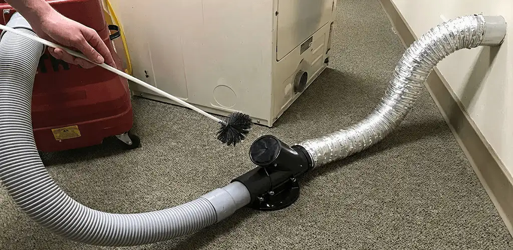 Dryer vent cleaning service removing lint from a dryer duct connection in Louisville, KY