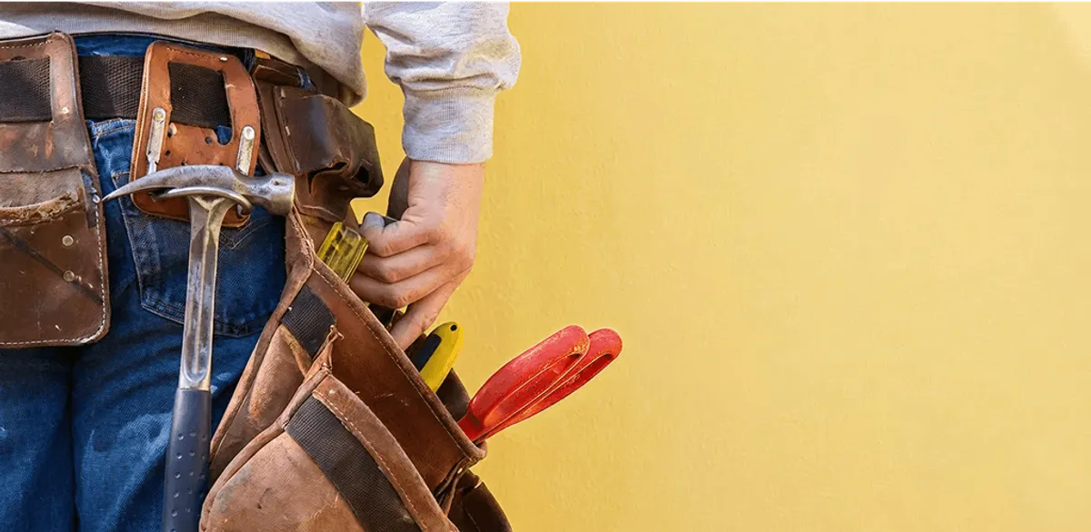 Handyman with tool belt ready for home repairs and maintenance in Louisville, KY
