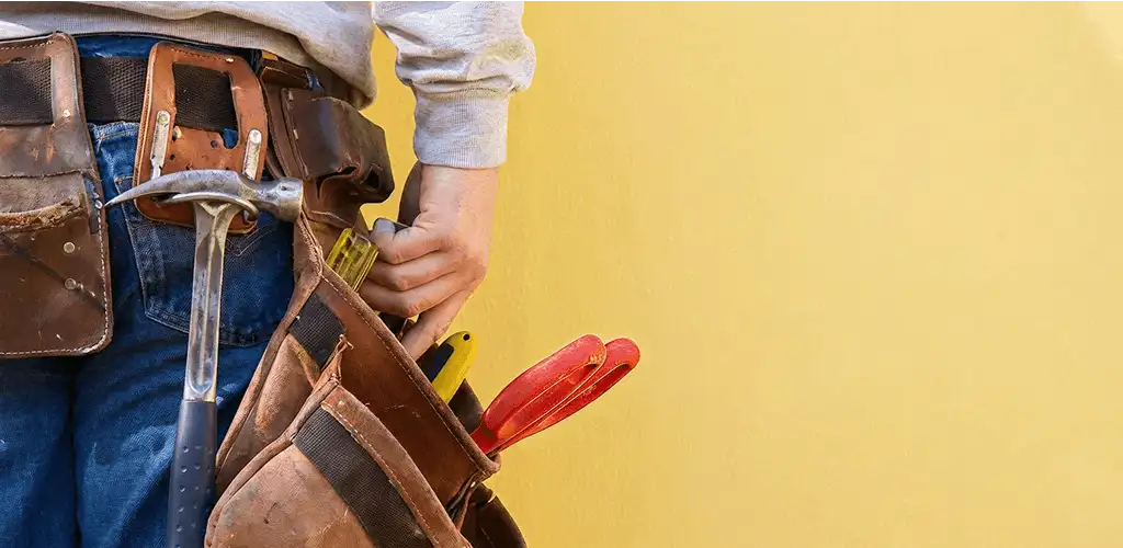 Handyman with tool belt ready for home repairs and maintenance in Louisville, KY