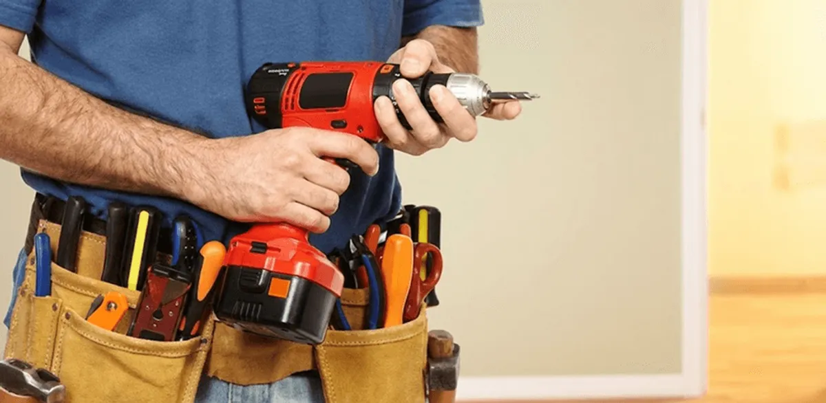 Handyman holding a power drill for home repairs and installations in Louisville, KY