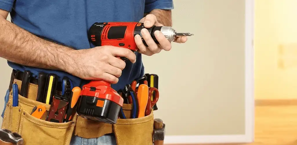 Handyman holding a power drill for home repairs and installations in Louisville, KY
