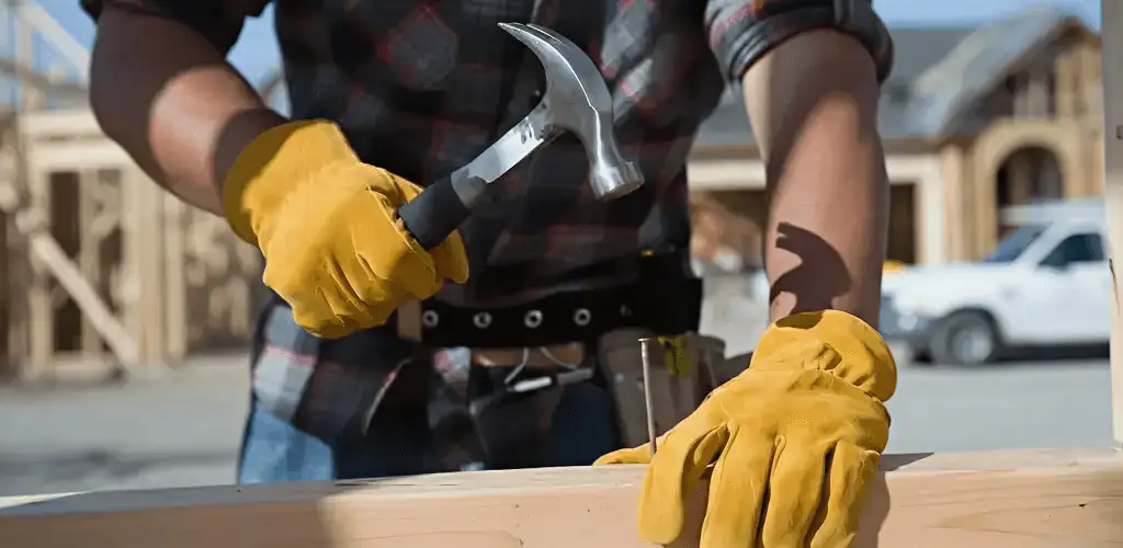 Handyman fixing wood trim with a hammer for home repairs in Louisville, KY